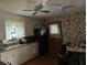 Kitchen with white cabinets, black appliances, and floral wallpaper at 8520 Delhi Rd, North Charleston, SC 29406