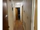 Long hallway with wood floors and wallpaper at 8520 Delhi Rd, North Charleston, SC 29406