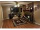 Living room with brick fireplace, hardwood floors, and large TV at 8520 Delhi Rd, North Charleston, SC 29406