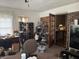Home office features a desk, shoe rack, and view into kitchen at 8520 Delhi Rd, North Charleston, SC 29406