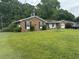 Brick ranch house with attached garage and yard at 8520 Delhi Rd, North Charleston, SC 29406