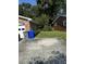 Side yard with a large, grassy area and trash bins at 8520 Delhi Rd, North Charleston, SC 29406