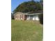 Brick ranch house with a solar panel system and a well-maintained lawn at 8520 Delhi Rd, North Charleston, SC 29406