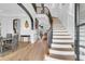 Elegant curved staircase with dark metal railing at 1913 Mooring Line Way, Mount Pleasant, SC 29466