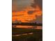 Fiery sunset over calm water with a dock in the foreground at 1913 Mooring Line Way, Mount Pleasant, SC 29466