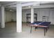 Unfinished basement with ping pong table and storage shelving at 32 41St Ave, Isle of Palms, SC 29451