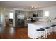Modern kitchen with stainless steel appliances and an island with seating at 32 41St Ave, Isle of Palms, SC 29451