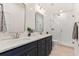 Modern bathroom with double vanity, quartz countertops, and a walk-in shower at 1462 Tangles Trl, Charleston, SC 29492