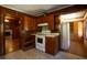 Kitchen with wood cabinets, white appliances, and wood paneling at 617 Venning St, McClellanville, SC 29458