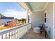 Covered porch with white railing and neighborhood view at 1118 Burkets Bend Ln, Charleston, SC 29492