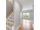 Stunning stairway with white risers, light wood handrail, and access to upper level at 517 Royall Ave, Mount Pleasant, SC 29464