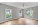 Light and airy bedroom with hardwood floors and three windows at 517 Royall Ave, Mount Pleasant, SC 29464