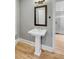 Elegant pedestal sink in a powder room with light gray walls at 517 Royall Ave, Mount Pleasant, SC 29464