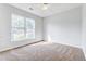 Well-lit bedroom with carpet flooring and a large window at 1206 Creek Stone Way, Hanahan, SC 29410