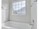 Bathroom featuring a bathtub and a large window at 1206 Creek Stone Way, Hanahan, SC 29410