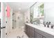 Modern bathroom with double vanity, glass shower, and hexagon tile floors at 9 Iron Frg Aly, Charleston, SC 29403