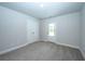 Well-lit bedroom with carpet flooring, double doors, and exterior access at 1327 Bootsie Way, McClellanville, SC 29458