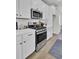 Modern kitchen with stainless steel range and white cabinets at 2004 Quiet Ibis Rd, Hanahan, SC 29410