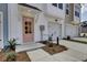 Townhome entrance with a light pink door and attached garage at 2006 Quiet Ibis Rd, Hanahan, SC 29410