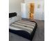 Spacious bedroom with striped bedding and ensuite bathroom at 2150 Spoleto Ln # B-6, North Charleston, SC 29406