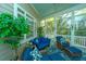 Spacious screened porch, comfortable seating, and lush landscaping views at 4233 Haulover Dr, Johns Island, SC 29455