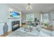 Cozy living room with fireplace, large windows and comfortable seating at 4233 Haulover Dr, Johns Island, SC 29455