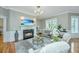 Elegant living room with fireplace, large windows and comfortable seating at 4233 Haulover Dr, Johns Island, SC 29455