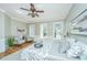 Bright main bedroom with hardwood floors, large windows, and a ceiling fan at 4233 Haulover Dr, Johns Island, SC 29455