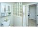 Bathroom with glass block shower, white toilet and vanity at 4233 Haulover Dr, Johns Island, SC 29455