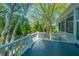 Elevated deck with white railings and scenic wooded views at 4233 Haulover Dr, Johns Island, SC 29455