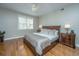 Bright bedroom featuring hardwood floors and a king-size bed at 4233 Haulover Dr, Johns Island, SC 29455