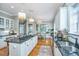 Spacious kitchen featuring granite countertops, white cabinets, and hardwood floors at 4233 Haulover Dr, Johns Island, SC 29455