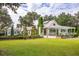 White house with a metal roof and lush landscaping at 4285 Clover Hill Rd, Green Pond, SC 29446