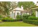 White cottage with metal roof, landscaping, and a pergola at 4285 Clover Hill Rd, Green Pond, SC 29446
