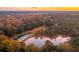 Aerial view of property with two ponds and bridge at sunset at 4285 Clover Hill Rd, Green Pond, SC 29446