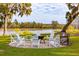 Fire pit with white Adirondack chairs near a pond at 4285 Clover Hill Rd, Green Pond, SC 29446