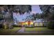 House exterior at dusk with brick walkway and lush landscaping at 4285 Clover Hill Rd, Green Pond, SC 29446