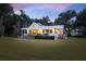 Charming white home with a metal roof, a large window, and a well-manicured lawn at 4285 Clover Hill Rd, Green Pond, SC 29446