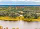 Aerial view showcasing a home surrounded by lush trees and a lake at 4285 Clover Hill Rd, Green Pond, SC 29446