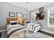Striped twin beds in a room with a mounted turkey and natural light at 4285 Clover Hill Rd, Green Pond, SC 29446