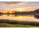 Sunset over calm lake with colorful sky reflected in water at 4285 Clover Hill Rd, Green Pond, SC 29446
