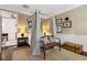 Primary bedroom with four-poster bed and sitting area at 4285 Clover Hill Rd, Green Pond, SC 29446