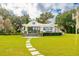 White house with a pergola and stone pathway at 4285 Clover Hill Rd, Green Pond, SC 29446
