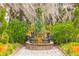 Ornate fountain in a garden setting with lush greenery at 4285 Clover Hill Rd, Green Pond, SC 29446