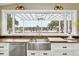 Farmhouse sink with brass fixtures and pergola view at 4285 Clover Hill Rd, Green Pond, SC 29446