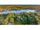 Aerial view of home on a lake with lush trees and landscape at 4285 Clover Hill Rd, Green Pond, SC 29446