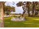 Fire pit area with white chairs overlooking a pond at 4285 Clover Hill Rd, Green Pond, SC 29446