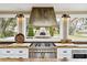 Modern kitchen features a professional range and views of an outdoor pizza oven at 4285 Clover Hill Rd, Green Pond, SC 29446