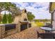 Brick patio with outdoor kitchen, pizza oven, and seating area at 4285 Clover Hill Rd, Green Pond, SC 29446