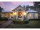 Home exterior at dusk featuring a large window and landscaping at 4285 Clover Hill Rd, Green Pond, SC 29446